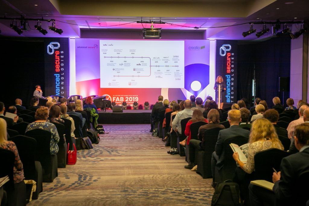 Delegates sitting and watching FAB 2019 presentation, advanced secure branded stage.