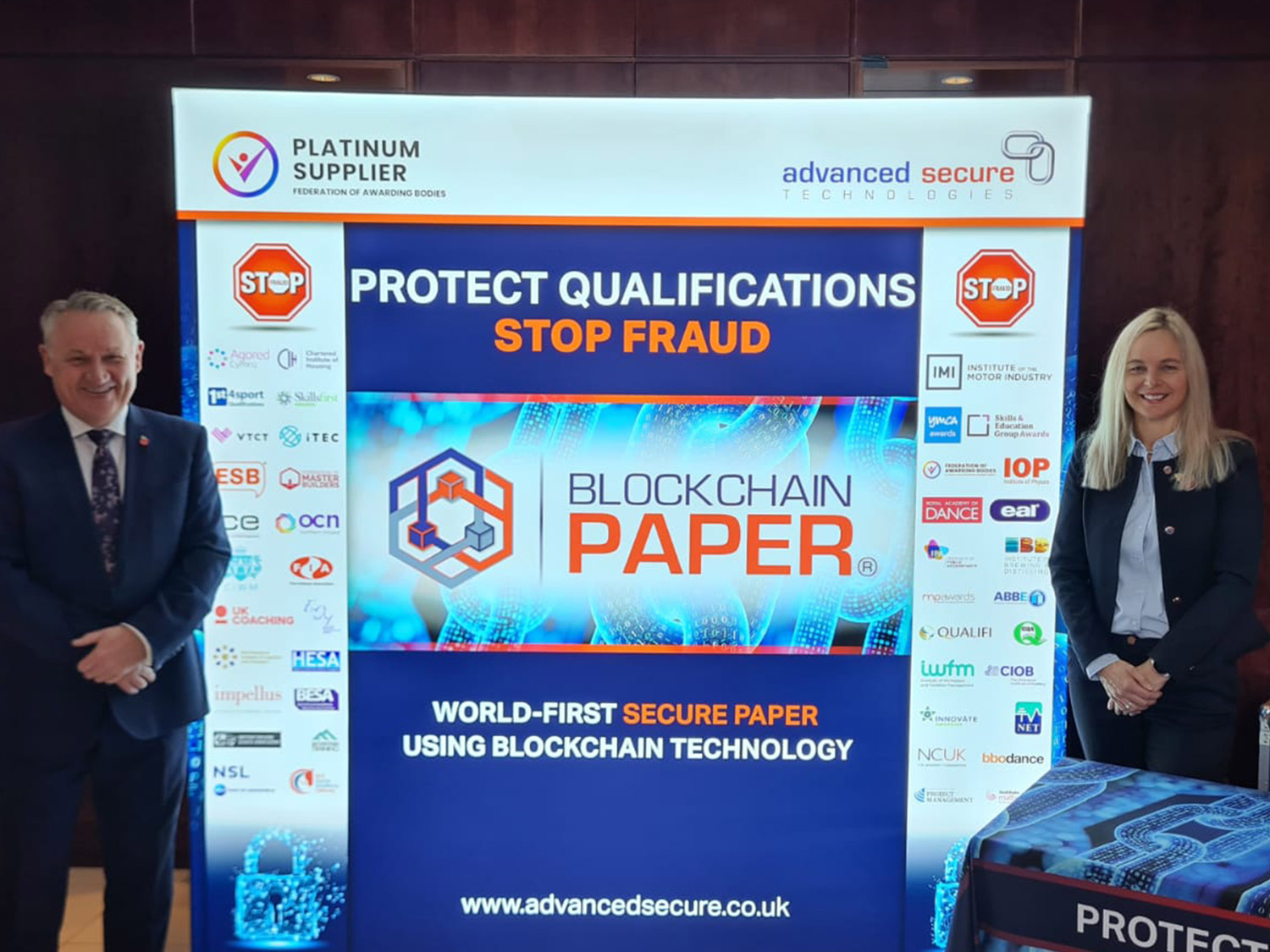 Advanced Secure directors standing by FAB2021 banner - Blockchain Paper
